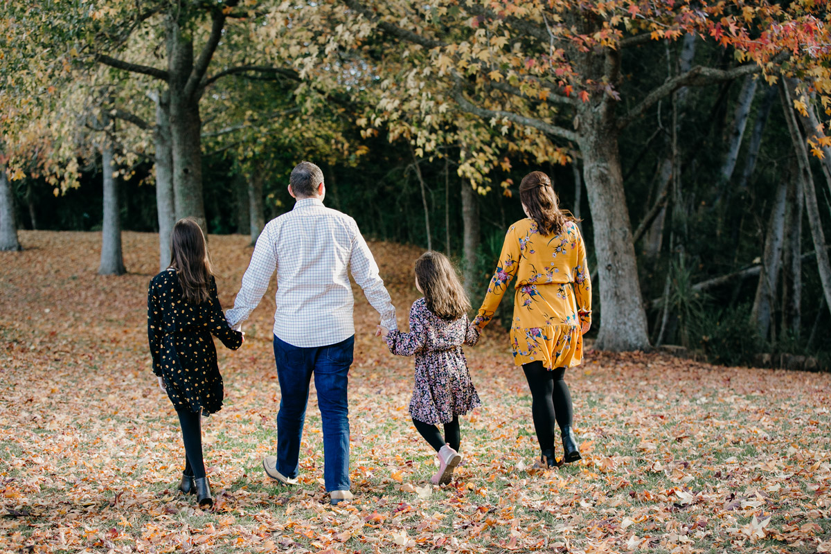 family walking in autumn lifestyle portrait photoshoot session in west auckland. Photos by sarah weber photography