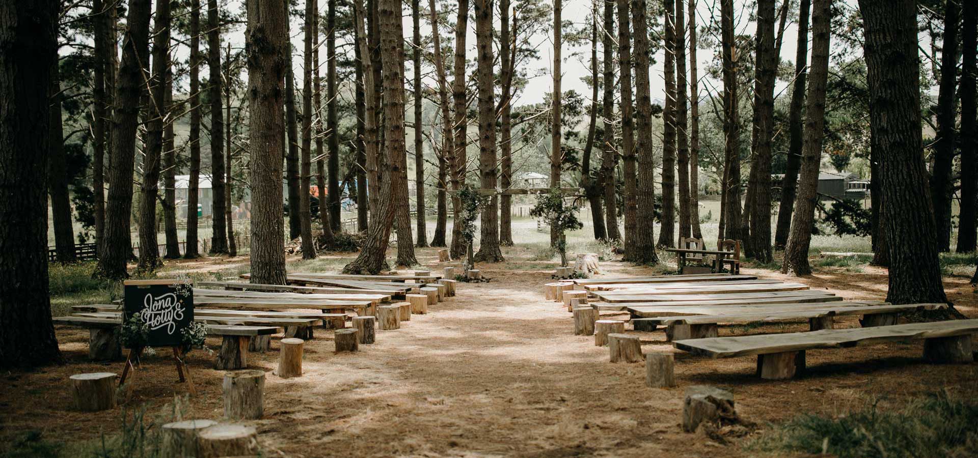 Wedding ceremony in west auckland forrest at diy rustic barn venue by sarah weber photography
